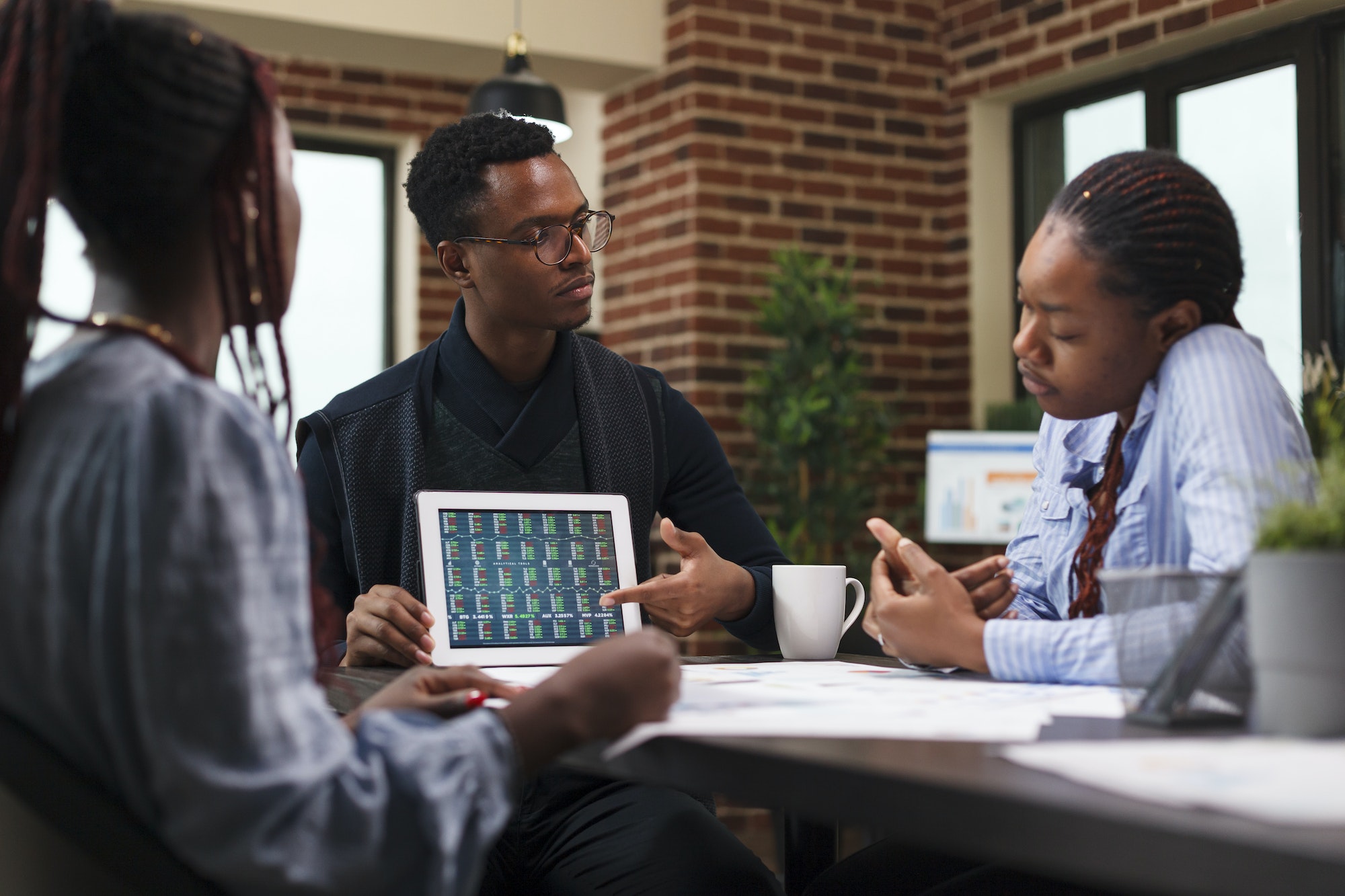 Business development company project manager pointing financial analysis on tablet